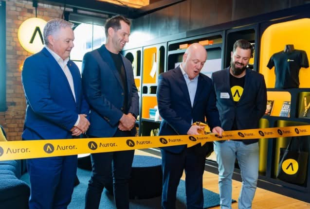 Ribbon cutting at the office opening, with black and yellow custom display cabinetry